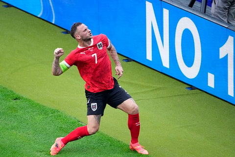 Marko Arnautovic celebrates after scoring Austria's third goal 